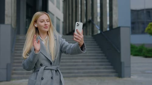 Stylish Woman Video Calling on Smartphone Outdoors