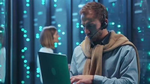 A Dedicated Data Center Professional Focused on Tasks with a Headset and Laptop