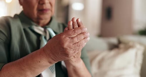 Senior Woman Massaging Her Wrinkled Hands