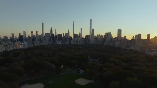 Aerial Views Showcase a Sunset Over Central Park Illuminating Vibrant Trees Against the Iconic