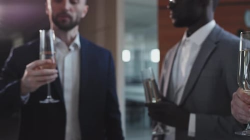Corporate Group Cheers With Champagne at the Office