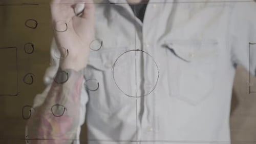 Coach Drawing Soccer Tactics on Glass