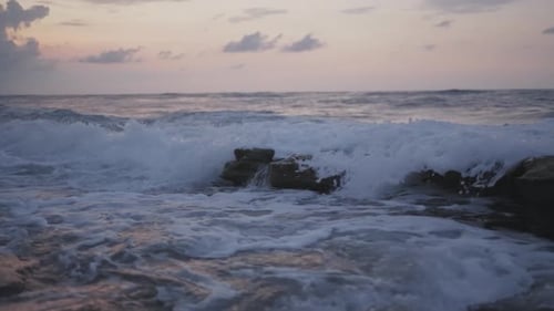 Wave crashing over rocks with white wash splash. Filmed in super slow motion.