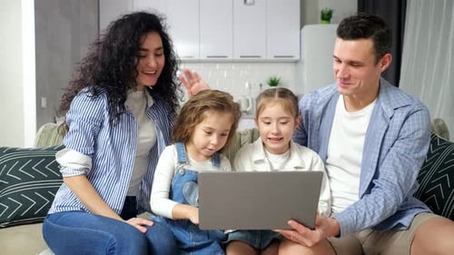 Family Talks with Relatives on Videocall Via Laptop