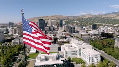 American Flag Waving Over a Vibrant Cityscape