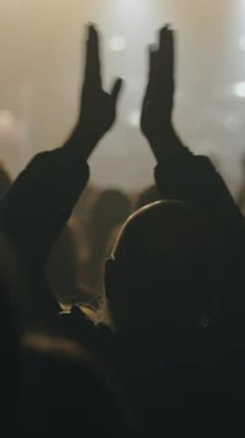 Silhouette of Audience Clapping Hands at Live Event