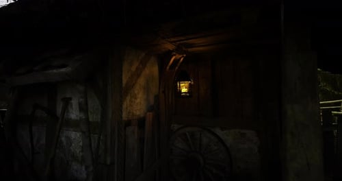 Old Lantern Swinging in Rustic Barn