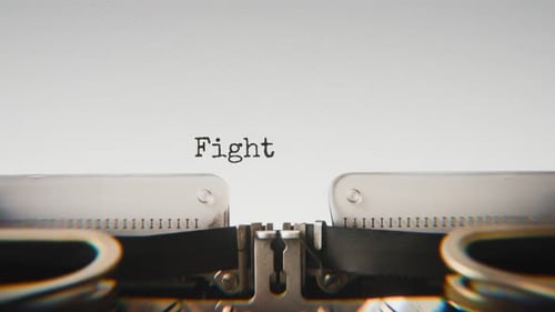 Old mechanical typewriter typing Fight Injustice in a close-up view.