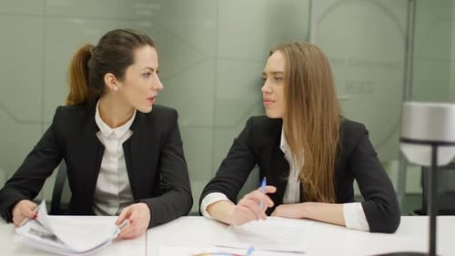 Professional Women Collaborating in a Bright Office Meeting