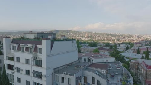 Aerial establishing shot overhead a resort rooftop in downtown Georgia
