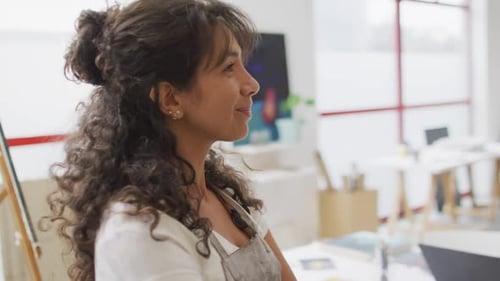 woman smiles in a bright office, with copy space