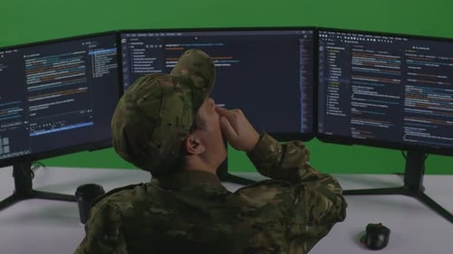 Tired Man Soldier Yawning Before Sleeping While Write Code With Multiple Screens In Green Screen