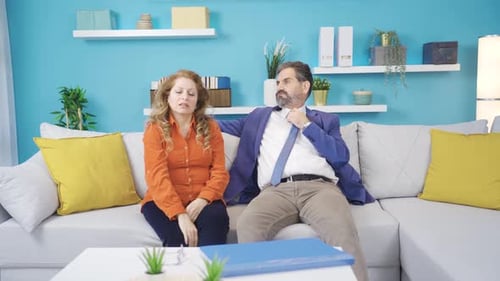 Couple Arguing on Couch in Home Living Room