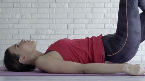 Woman Exercising on a Yoga Mat in Home