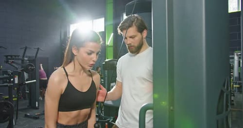 Portrait of Young Caucasian Woman Giving Five to Her Trainer and Laughing After Using Trx Straps and