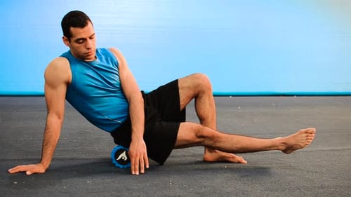 Man Using Foam Roller for Muscle Self Massage