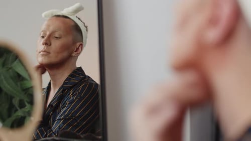 Theater Male Actor Applies Face Powder to His Face with a Soft Sponge in the Dressing Room Looking
