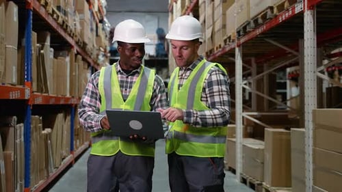 Manager Giving Instructions to Employee in Warehouse
