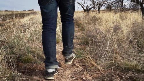 Slow Motion Male hiking with jeans at grass land of Cappadocia, Turkey Silk Road