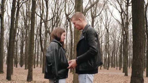 Happy Young Couple in Love Walking in Autumn Park Hugging Kissing and Having Fun
