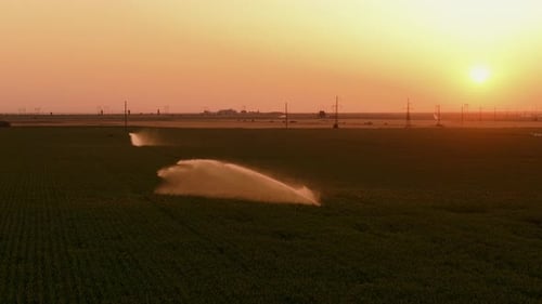 Irrigation system in agricultural field at sunset, Aerial close up view
