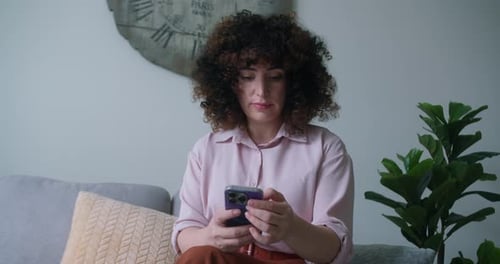 A Woman Typing on Mobile Phone Screen and Chatting in Living Room Woman's Hands Using Text Messages