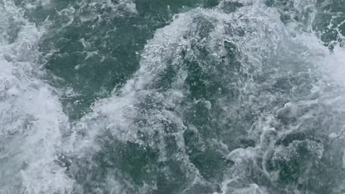 Cinematic Close-Up of Turbulent Boat Wake and White Foam on Ocean