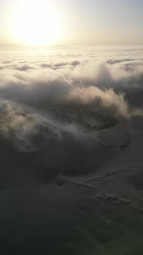 Aerial video above fog in the dunes of Huacachina Peru