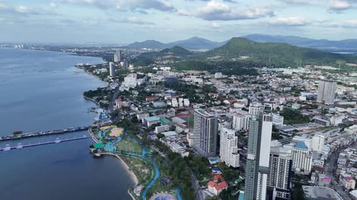 Aerial view of a coastal city captured by drone with beautiful surrounding landscapes.