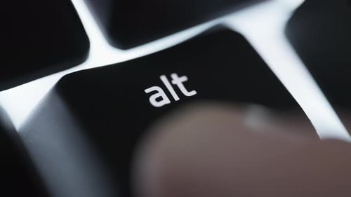 Pressing and holding the ALT button on black computer keyboard