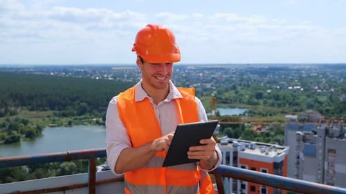 Construction Engineer Using Tablet on Building Rooftop