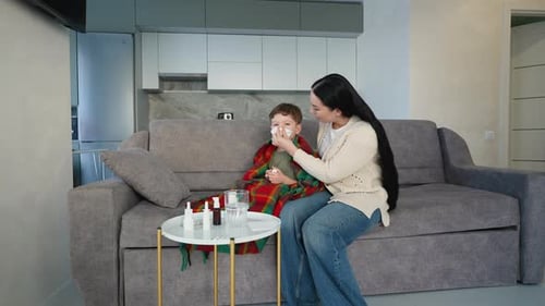 Caring Woman Helping Sick Child with Cold Symptoms