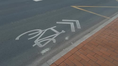 Roadway Featuring Worn Grey Bicycle Lane Marking on Side