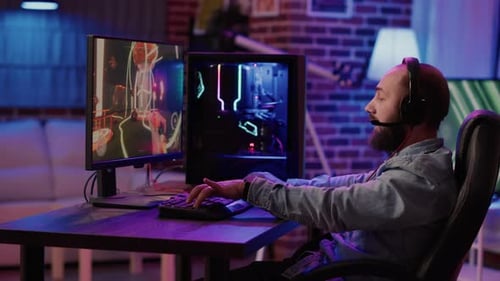 Man Excitedly Playing Video Games on Computer