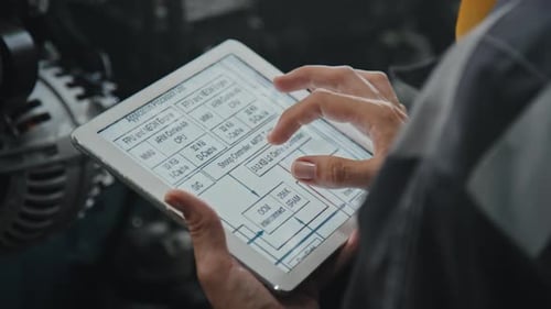 Adult Using Tablet with Diagrams
