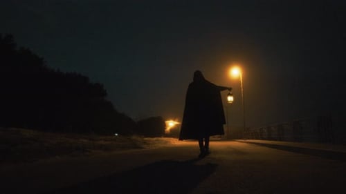 A Mysterious Man Walks In A Dark Street On Halloween Ghost Night