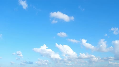 White Clouds Drifting Across Vibrant Blue Sky
