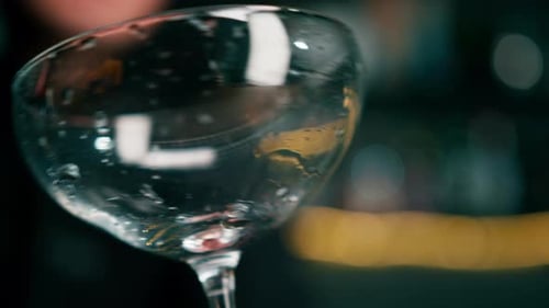 Ice Being Added to Clear Coupe Glass