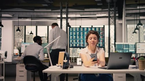 Smiling Woman Participating in Video Call From Workstation in Office