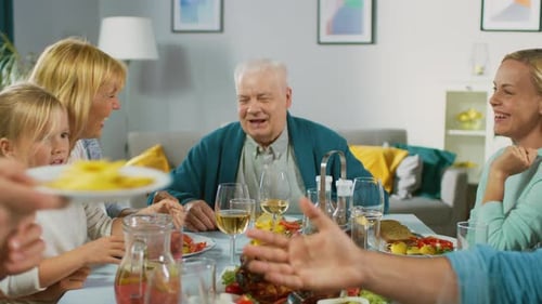 Family and Grandparents enjoying Dinner at Home