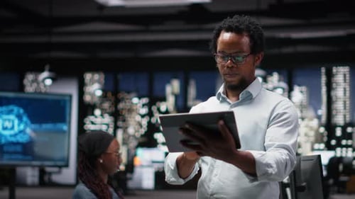 Programmer in Office Developing App Using Tablet Writing Code