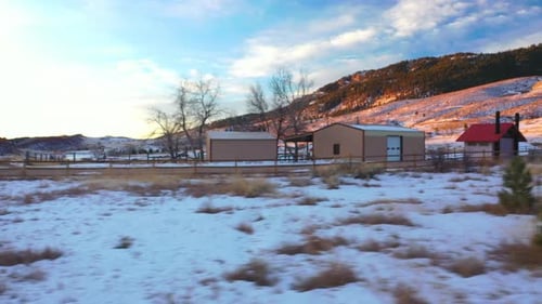 low angle snow covered mountain fairy tale wooden cabin chalets dolly right at sunrise..One Storeyed