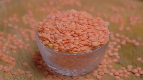 Bowl of Red Lentils on Wooden Table