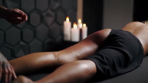 Man Receives Leg Massage in Candlelit Spa