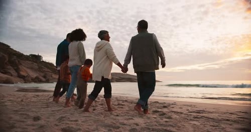 Happy, holding hands and relax with big family at beach for travel, freedom and vacation
