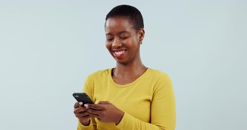 Woman, smile or typing on smartphone in studio, scroll social media or reading funny notification