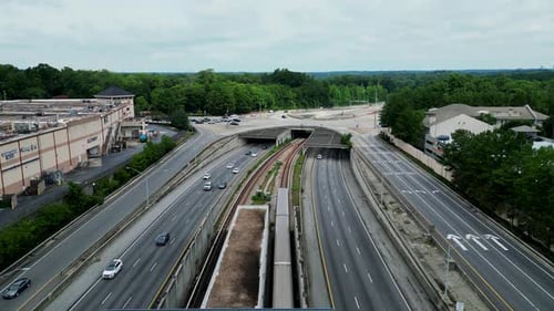 Forwards tracking of subway train passing under road bridge on multilevel road intersection. Railway