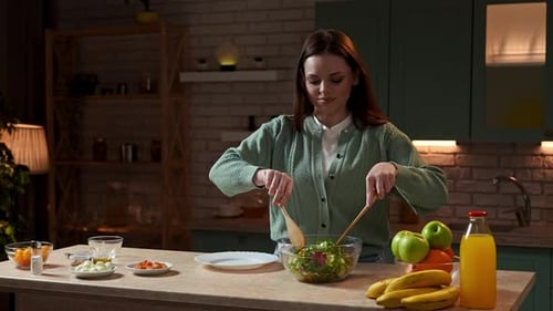 Woman Preparing a Colorful Healthy Salad in Kitchen