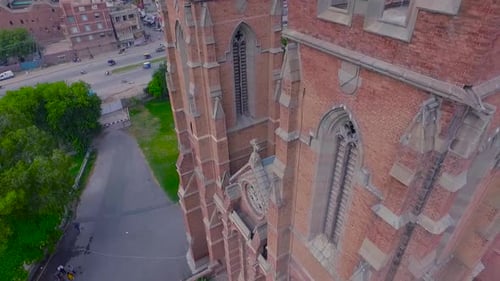 A Church building side aerial close up view, A cross on the Church building, Traffic is moving on th