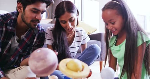 Parents, child and science project, help with education and building model of solar system